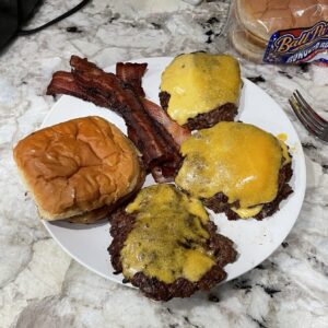 A delectable smash burger ready for assembly, with all ingredients lined up, eagerly awaiting the final touch of the best smash burger sauce