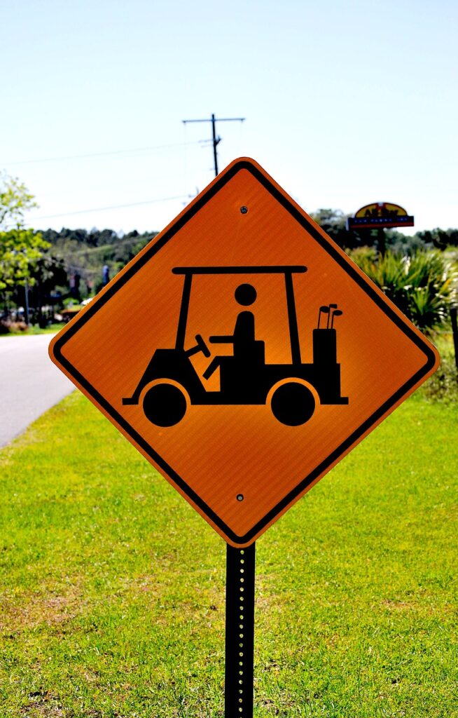 An illustrated street sign featuring a drawing of a golf cart, highlighting the key topic of our comprehensive guide: How to change a tire on a golf cart. This image subtly hints towards the importance of mastering this essential skill for any golf enthusiast.