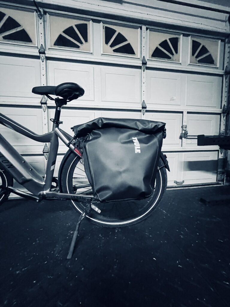 The Thule Shield Bike Pannier Bag, a must-have eBike accessory, mounted on an Aventon Level 2 rack.