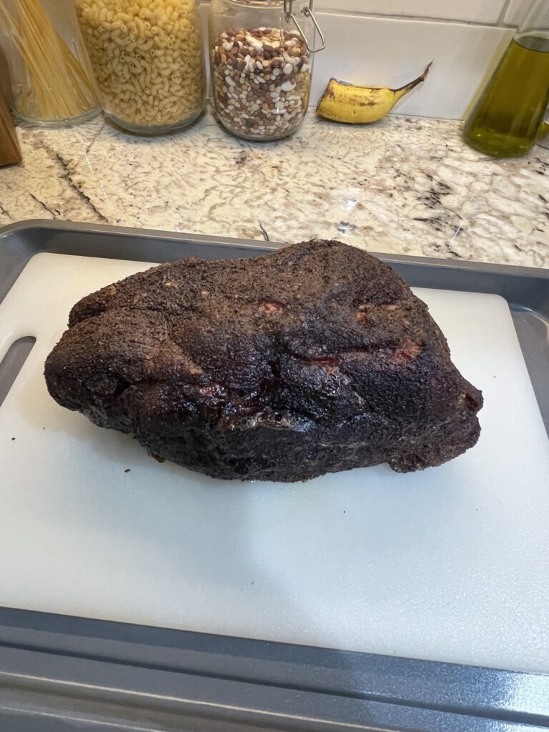 A smoked pork butt showcasing how long to smoke a pork butt at 250 on a Traeger grill.