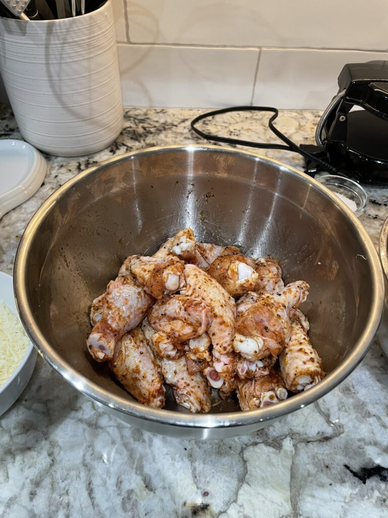 Smoke chicken wings - wings in a bowl after adding seasoning.