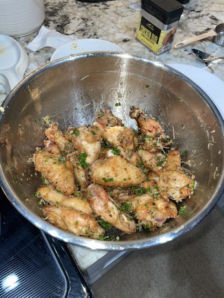 Smoked wings recipe - garlic parmesan wings sauced in a bowl.