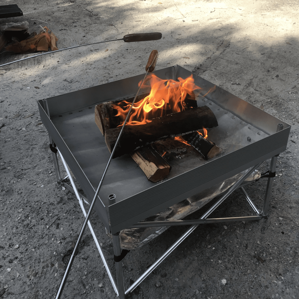 Delicious hot dogs being roasted over a campfire, highlighting how firestarters for camping can create the perfect flame for cooking