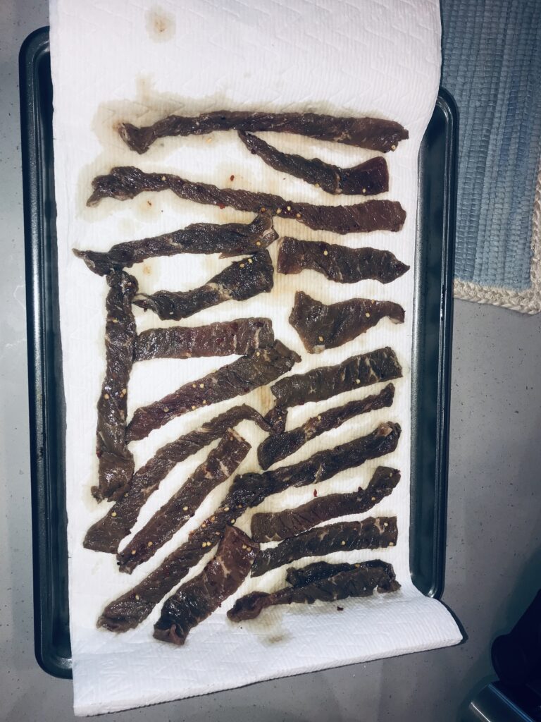 Delicious, freshly-cooked spicy beef jerky, made using Ninja Foodie Grill recipes, laid out to cool.