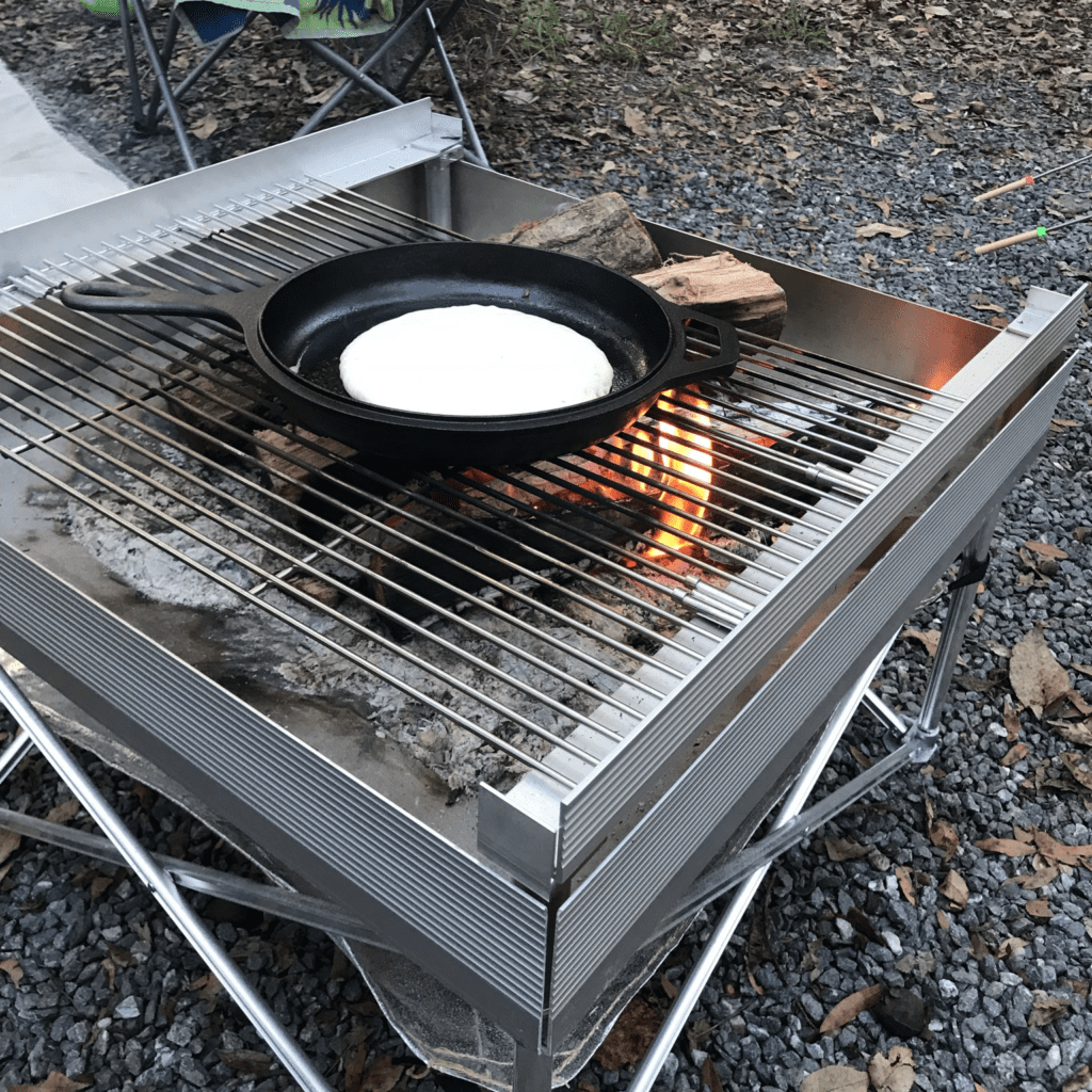 Fluffy pancakes cooking over an open flame, thanks to the use of reliable camping fire starters