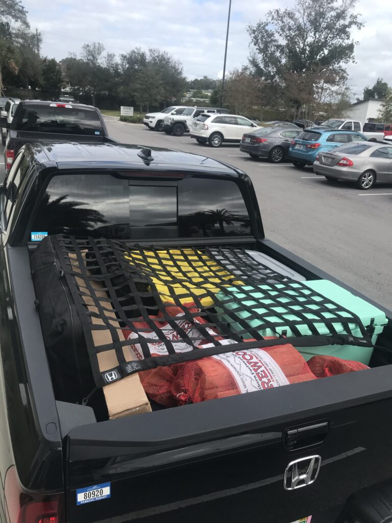 A truck bed packed full with all the necessary gear for a successful and comfortable truck camping trip.