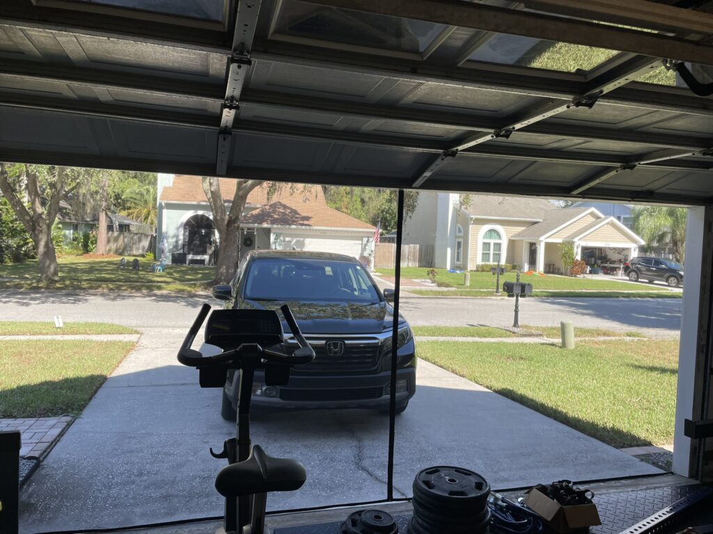 An inside look at a garage featuring garage screen doors, illustrating the functionality of a screen garage door.