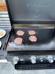 Smash burgers sizzling to perfection on the Blackstone grill, the embodiment of the Blackstone smash burger recipe.