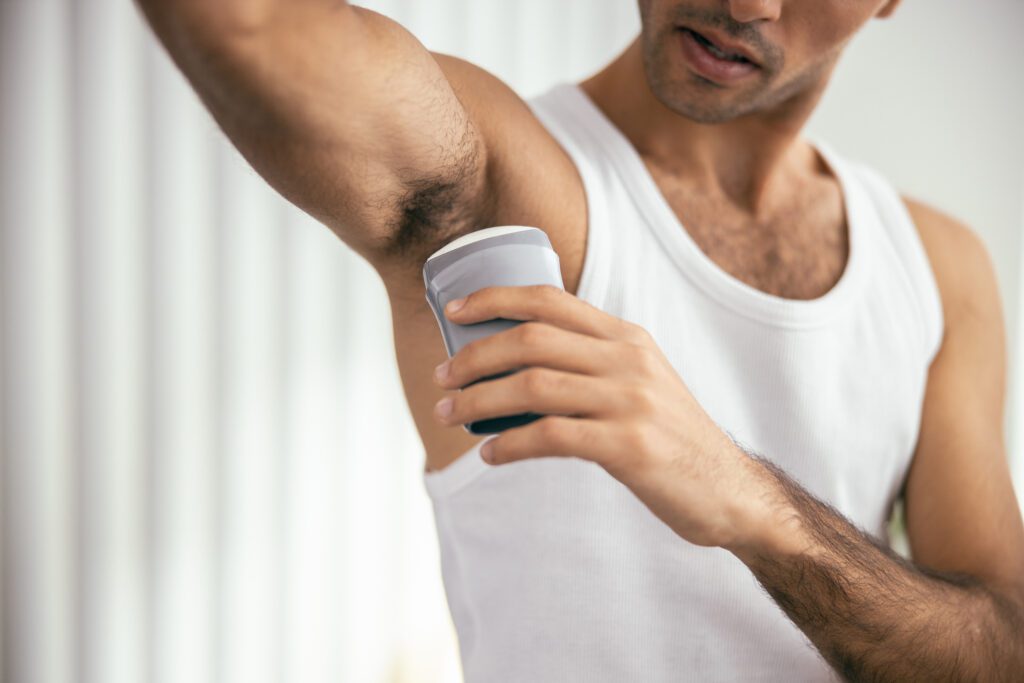 Man applying fragrance free deodorant for a comfortable and fresh underarm experience