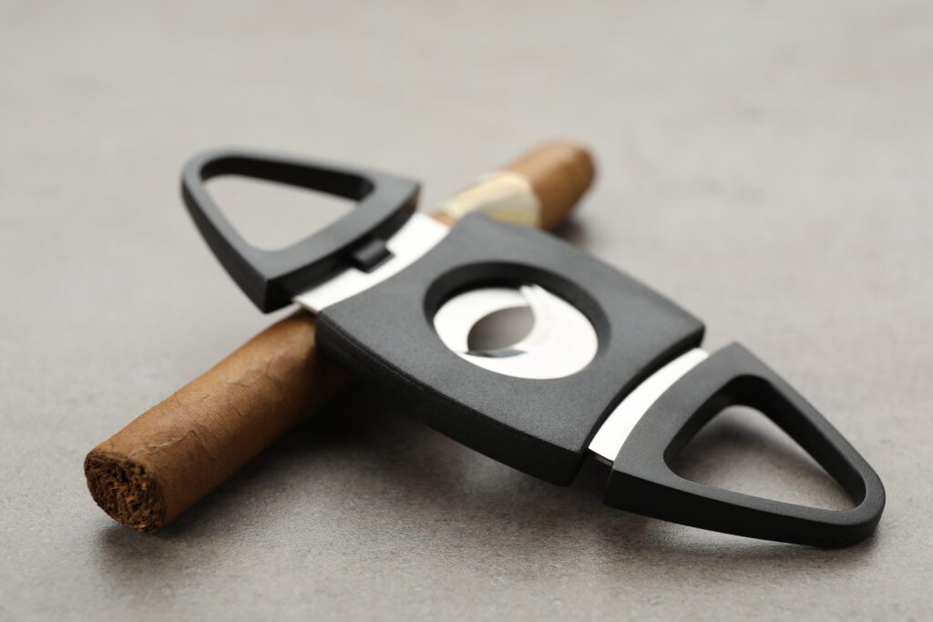 A close-up image showcasing a cigar cutter, a fundamental tool in the process of how to cut cigars.