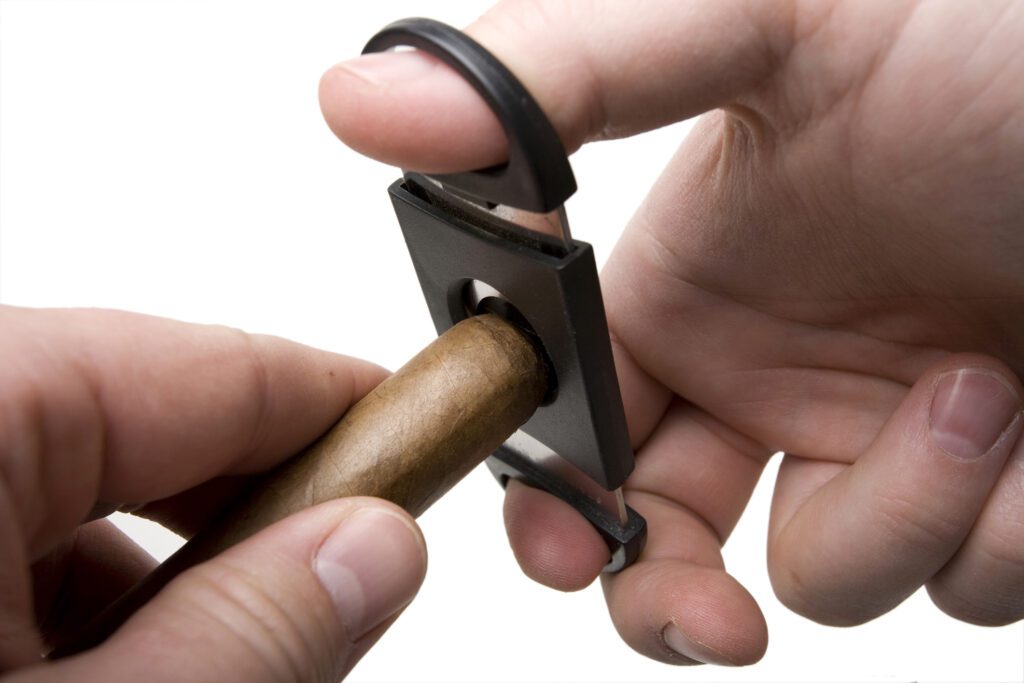 Showing the process not only how to cut a cigar with a cigar cutter, but also how to cut a cigar without a cutter.