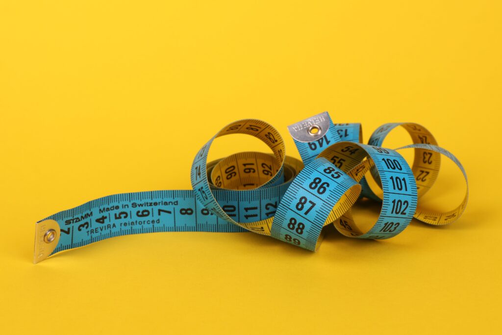 A tape measure used to visualize "How tall is Shaq O'Neal" and the heights of his family members.