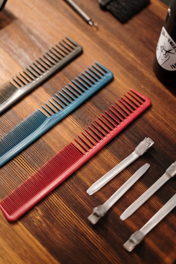 Close-up of essential barber tools like combs and razors, often used in creating mid taper and low taper fade haircuts.