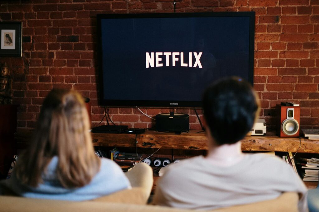 Image of a couple about to enjoy where to stream Christmas movies, particularly focusing on Netflix.