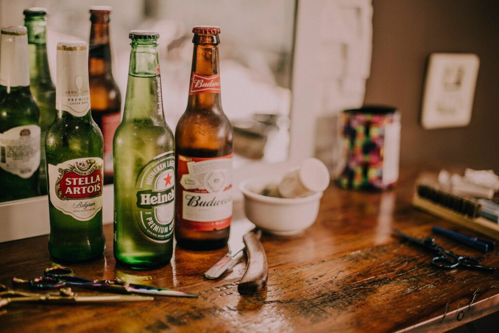 A collection of beer bottles featuring Budweiser, Heineken, and Stella symbolizing the broad range of ultra beer choices available for different tastes and nutritional preferences.