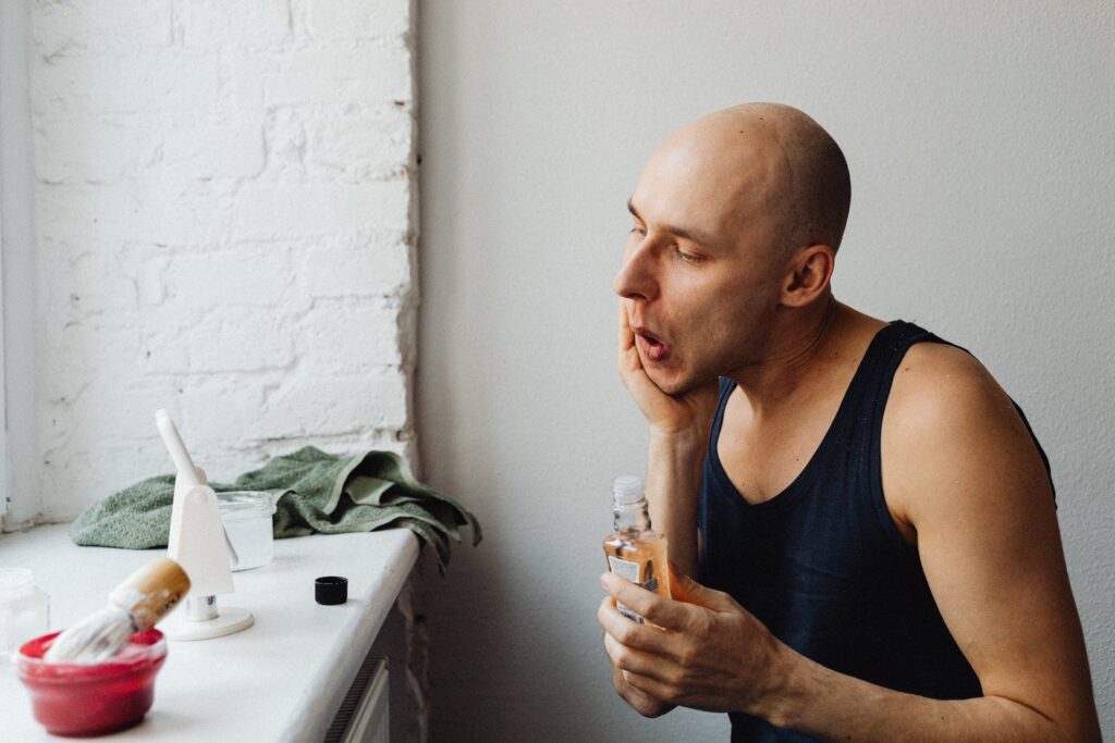 Man applying azzaro cologne, one of the best cologne for men.