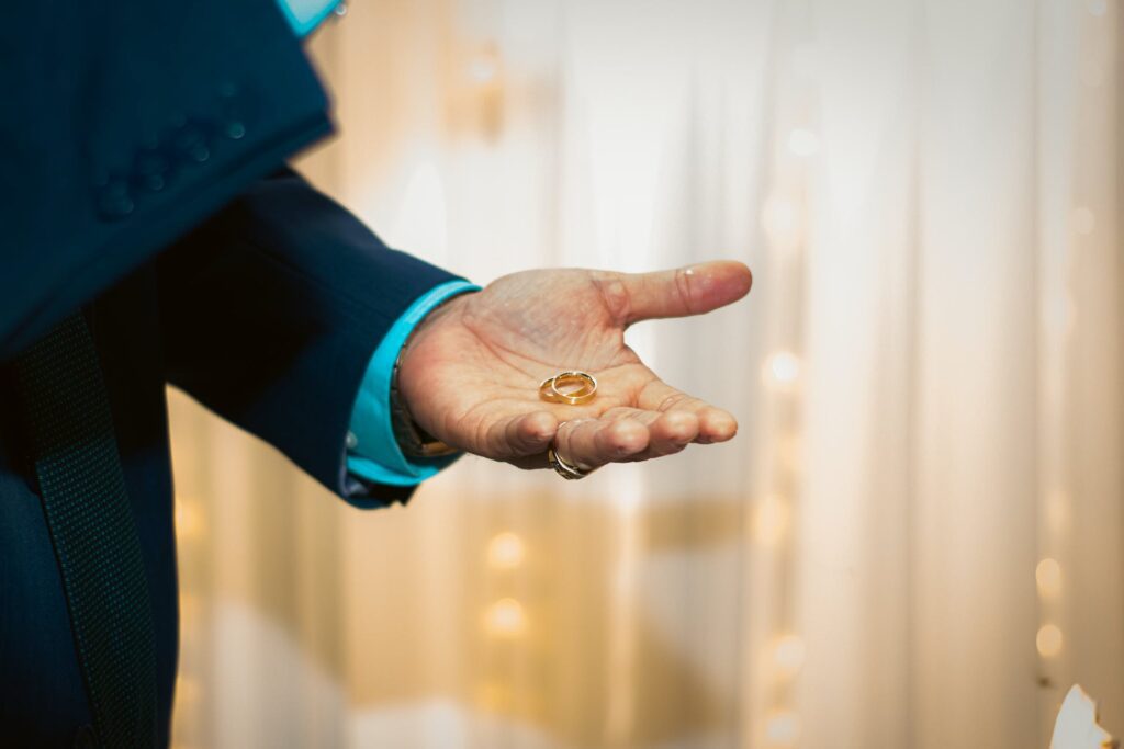 A symbolic moment of short best man speeches as the best man holds the wedding ring.