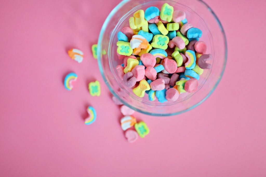 A close-up of a popular sugar cereal, Fruity Pebbles, in a bowl.