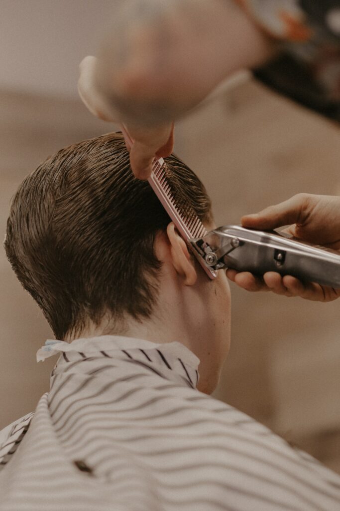 A gentleman displaying his classic taper cut, where the hair gradually shortens but does not fade to skin.