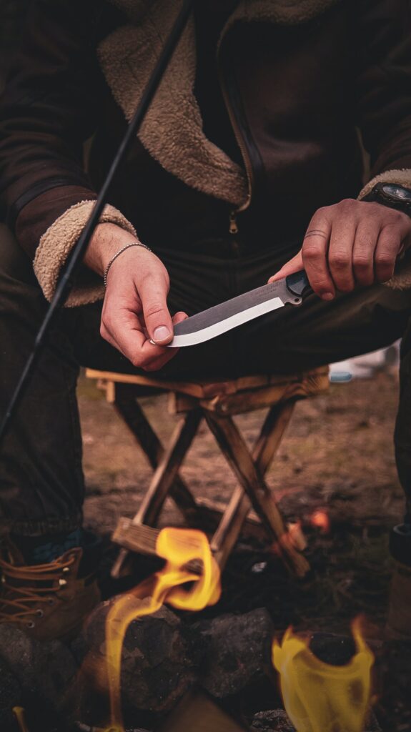 Step-by-step demonstration of cleaning, oiling, and sharpening a survival knife with a fixed blade.