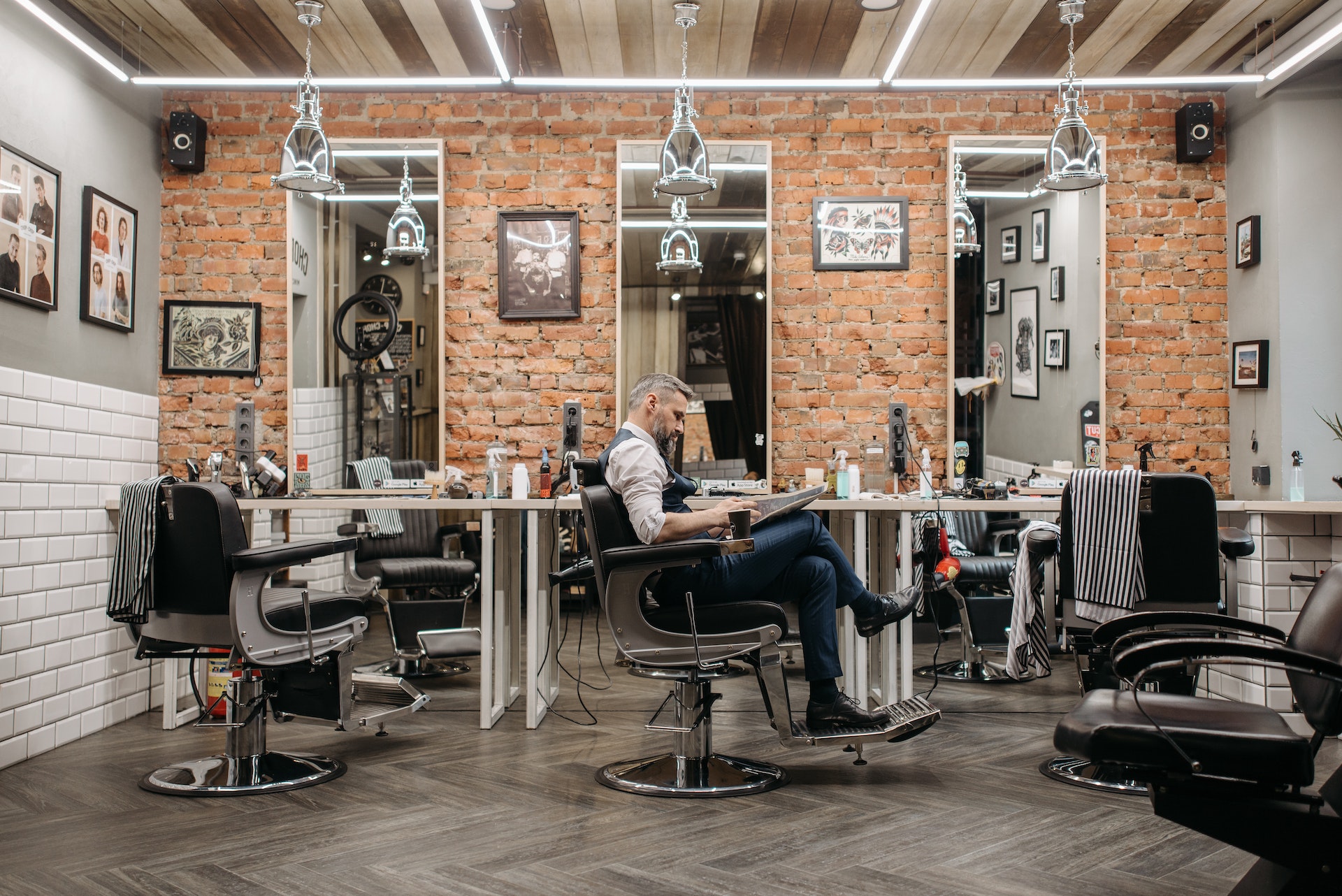 A row of barbershop chairs, where many customers receive their low taper fade haircuts.