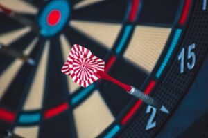 A dart hitting the target on an electronic dart board, demonstrating how to play darts.