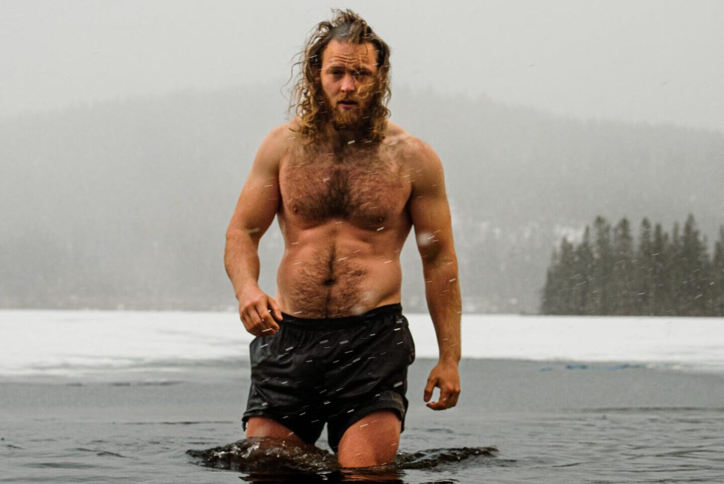 Man walking into cold water for his ice bath and cold plunge tub.