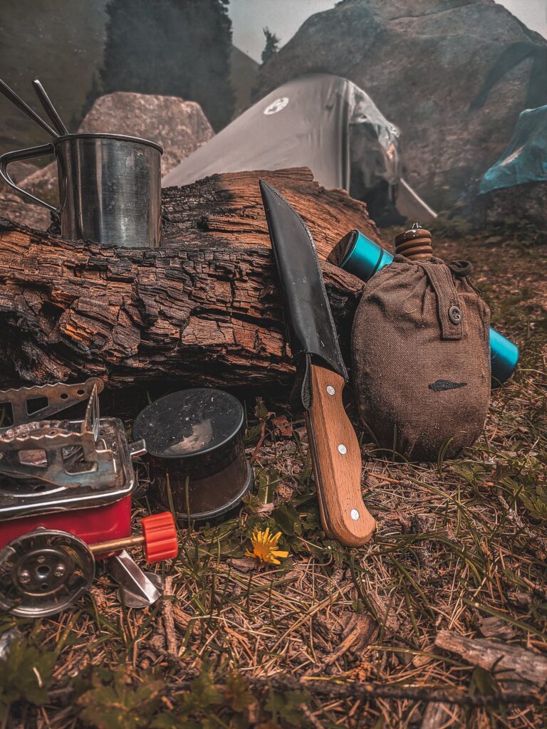 Comparative image depicting a survival knife alongside other outdoor tools, underscoring the importance and versatility of knives with a fixed blade.