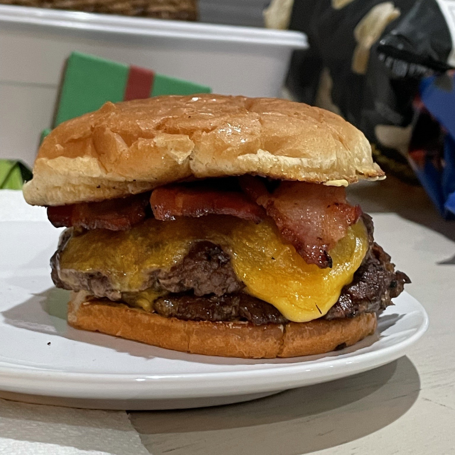 A delectable smash burger topped with creamy sauce and fresh lettuce on a toasted bun.